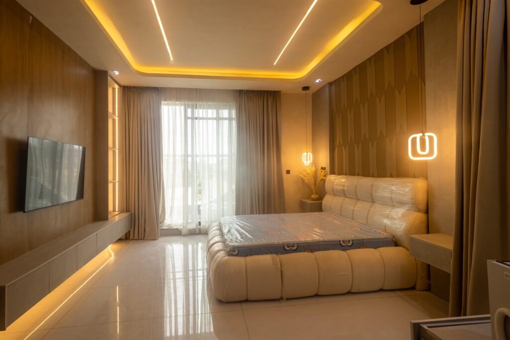 Brum Height 9: Furnished bedroom with a television wall and warm lighting